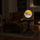 Illuminated Gibraltar globe glowing warmly on a side table next to an armchair, showing correct relative size.