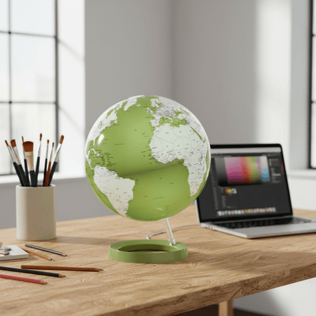 Green Light & Color globe on a desk in a creative artist studio.