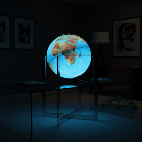 Illuminated Maranello globe glowing brightly in a dim modern office, acting as a mood light.